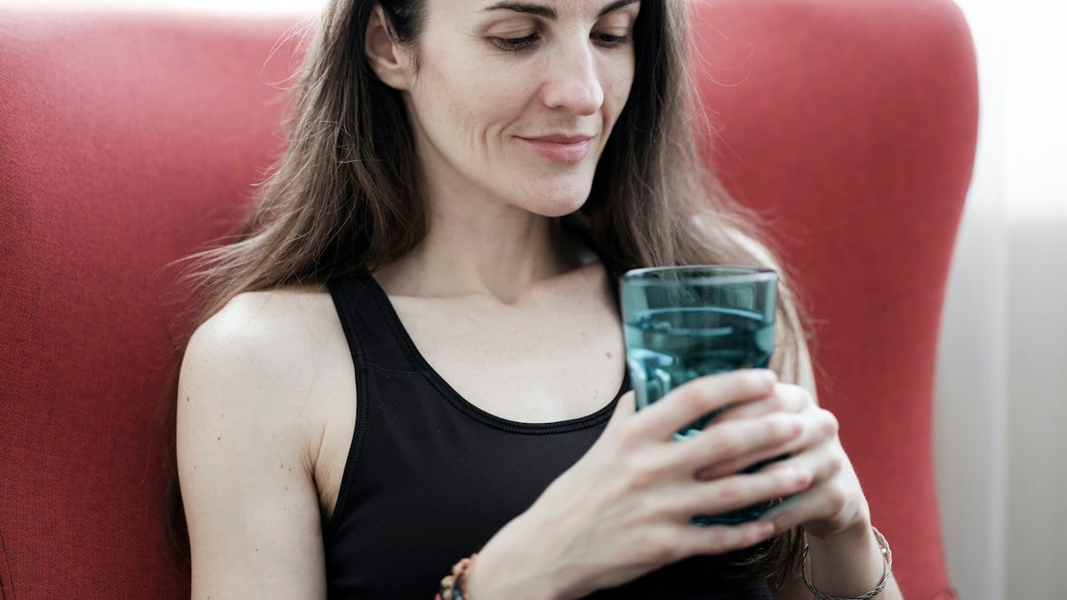 beautiful girl holding a glass of water